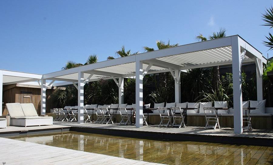 Pergola bioclimatique blanche version sur-mesure autoportée 14x4m pour un restaurant avec terrasse