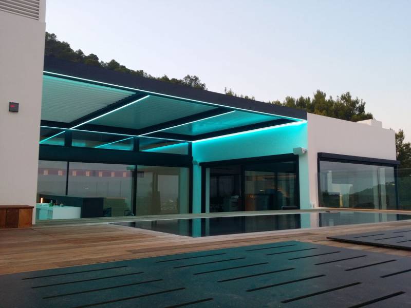 Eclairage par ruban LED RGB en applique périphérique sous poutre d'une pergola bioclimatique adossée